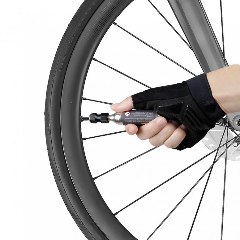 Topeak AirBooster Nano bike tire inflator with 16g CO2 cartridge in black, compact cycling accessories for quick inflation