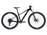 Liv Tempt 2 women's 2024 mountain bike with Shimano CUES U4000 drivetrain and disc brakes, shown in a natural outdoor setting.