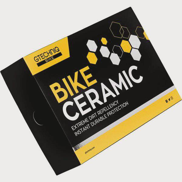 Gtechniq Bike Ceramic Kit in a workshop setting, featuring bottles of durable 24-month protective coating for bikes.