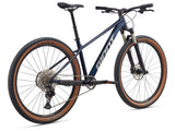 Giant Talon 29 mountain bike with Shimano Deore M6100 drivetrain and disc brakes, showing the bike's frame, wheels, and suspension.