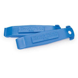 Park Tool TL-4.2 tyre lever set with spoke hook for bike maintenance, includes two durable plastic levers in a workshop setting.