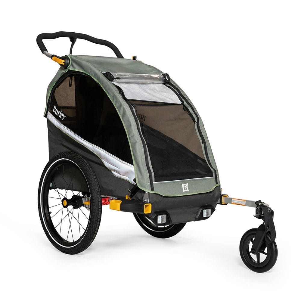 Burley D'Lite X single bike trailer and stroller with adjustable suspension, shown in a natural outdoor setting.