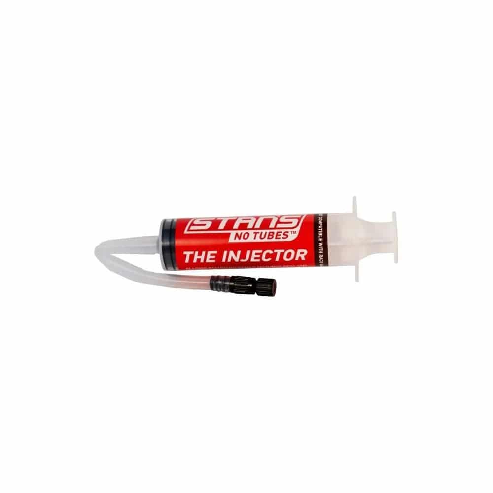 Stan's No Tubes tyre sealant injector for tubeless tires with Presta and Schrader valve compatibility, shown with the injector tool.