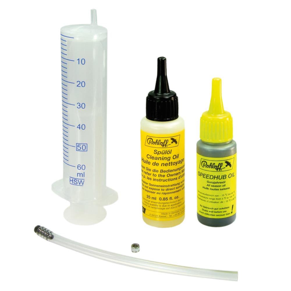 Rohloff Speedhub oil change kit for lubrication, featuring workshop tools and oil bottles for smooth gear performance.