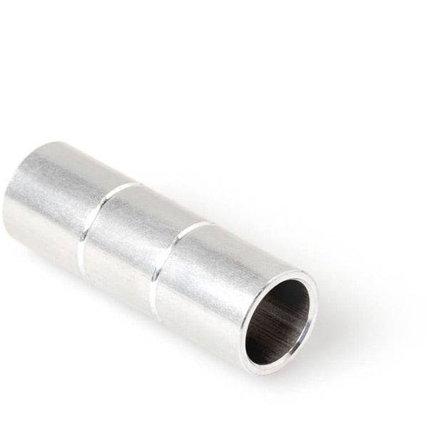 DT Swiss front axle spacer, 15mm by 57.2mm, genuine replacement part for bike wheel assembly, shown in workshop setting.