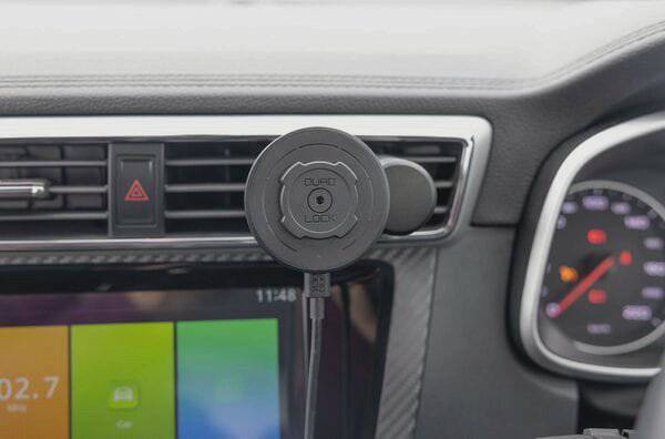 Quad Lock MAG Wireless Charging Head V2 fast 15W wireless charger mounted on a bike handlebar with Quad Lock mount accessories.
