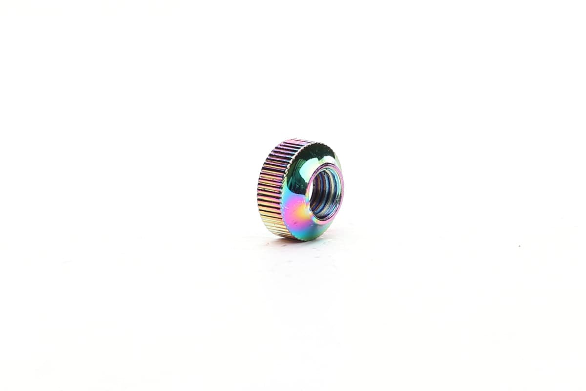 Fatty's tubeless valve nut with oil slick finish, durable component for secure sealing of tubeless valve stems.