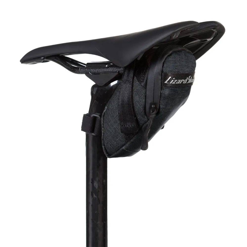 Lizard Skins Super Cache saddle bag in jet black attached to a bike, providing compact storage for cycling accessories.