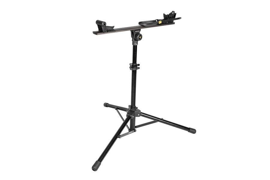 Topeak Prepstand X foldable bike workstand in black with 4-way adjustment for workshop use, supporting a bicycle securely.