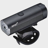 Infini KOR 800 front bike light with 800 lumens, rechargeable USB, multiple modes, mounted on a bicycle handlebar.