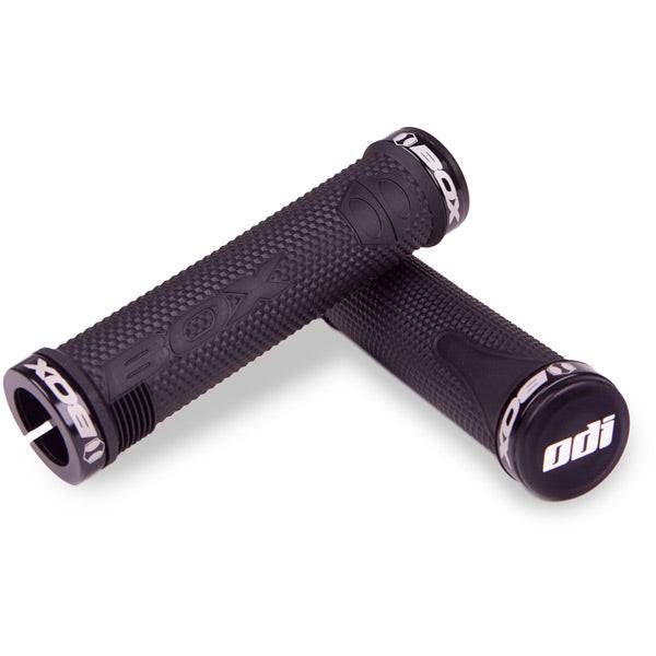 Black ODI BOX BMX lock-on grips with 130mm length, snap cap end plugs, and clamps for secure handlebar fit.