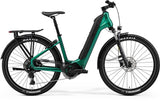 Merida eSpresso CC 400 EQ e-hybrid bike with 27.5-inch tires, integrated lights, mudguards, rack, lock, and suspension forks.