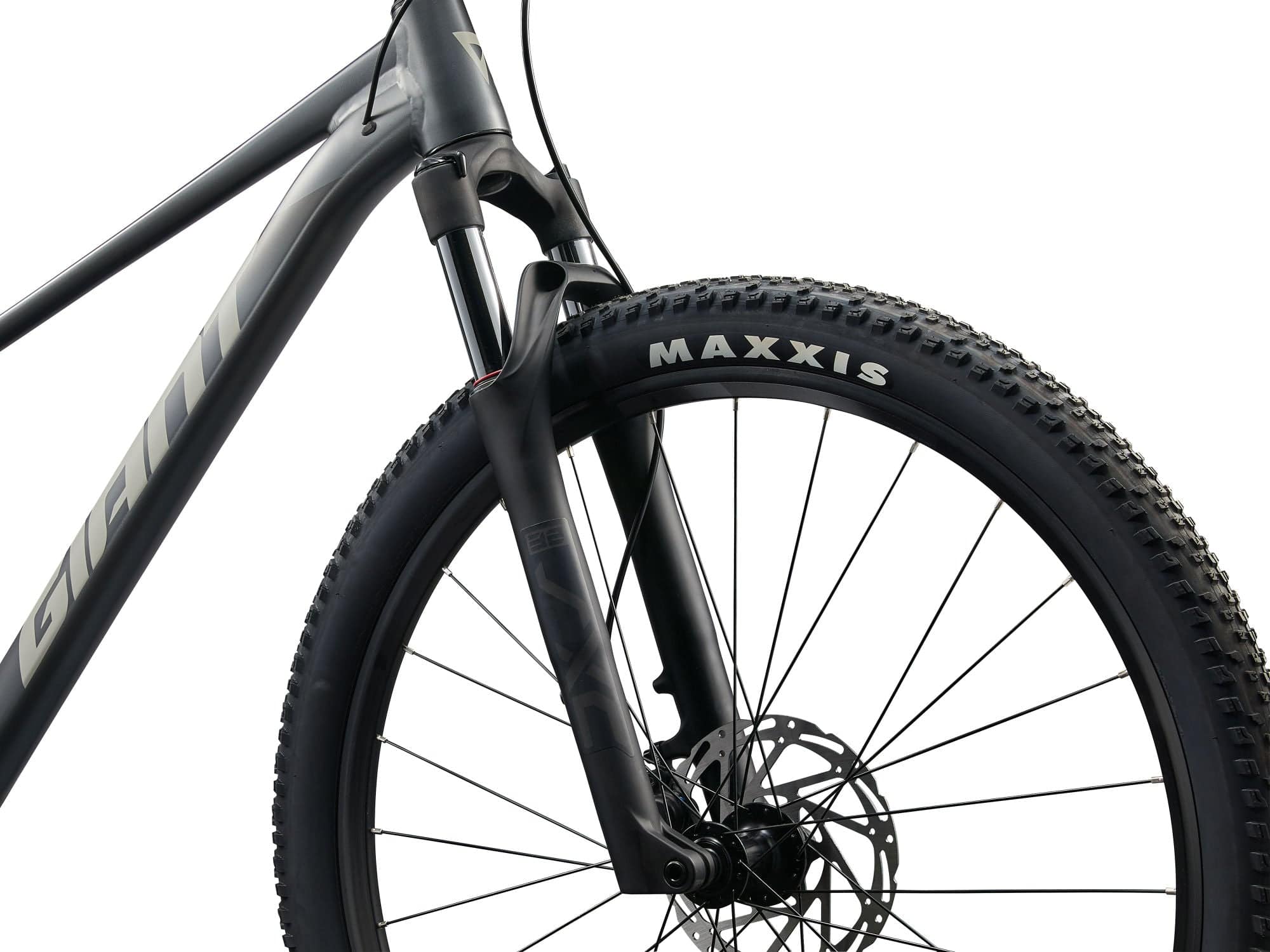 Giant Talon 29 1 mountain bike with Shimano CUES U6000 disc brakes, unisex MTB bike shown outdoors on rugged trail.