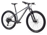 Giant Talon 29 1 mountain bike with Shimano CUES U6000 disc brakes, unisex design, black and green frame, outdoor trail setting