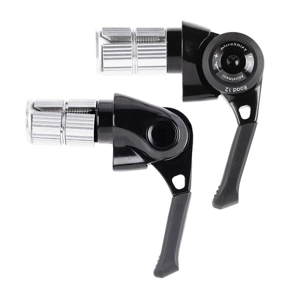MicroSHIFT road bike bar end shifters with index and friction modes mounted on drop handlebars.