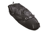 Topeak BackLoader bikepacking seat bag with water-resistant fabric and quick-release strap attached to a bicycle seat.
