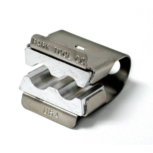 Park Tool AV-1 axle vice securely holds bike axles in a workshop bench vice for maintenance and repair tasks.