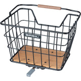 Black and natural brown Basil Norland MIK 23L bicycle basket shown on a bike, compatible with front and rear carrier.