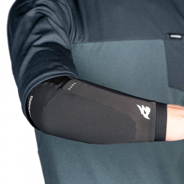 Bluegrass Aura Level 1 mountain bike elbow pads in blue, designed for trail and downhill protection, with adjustable straps and padded armor.