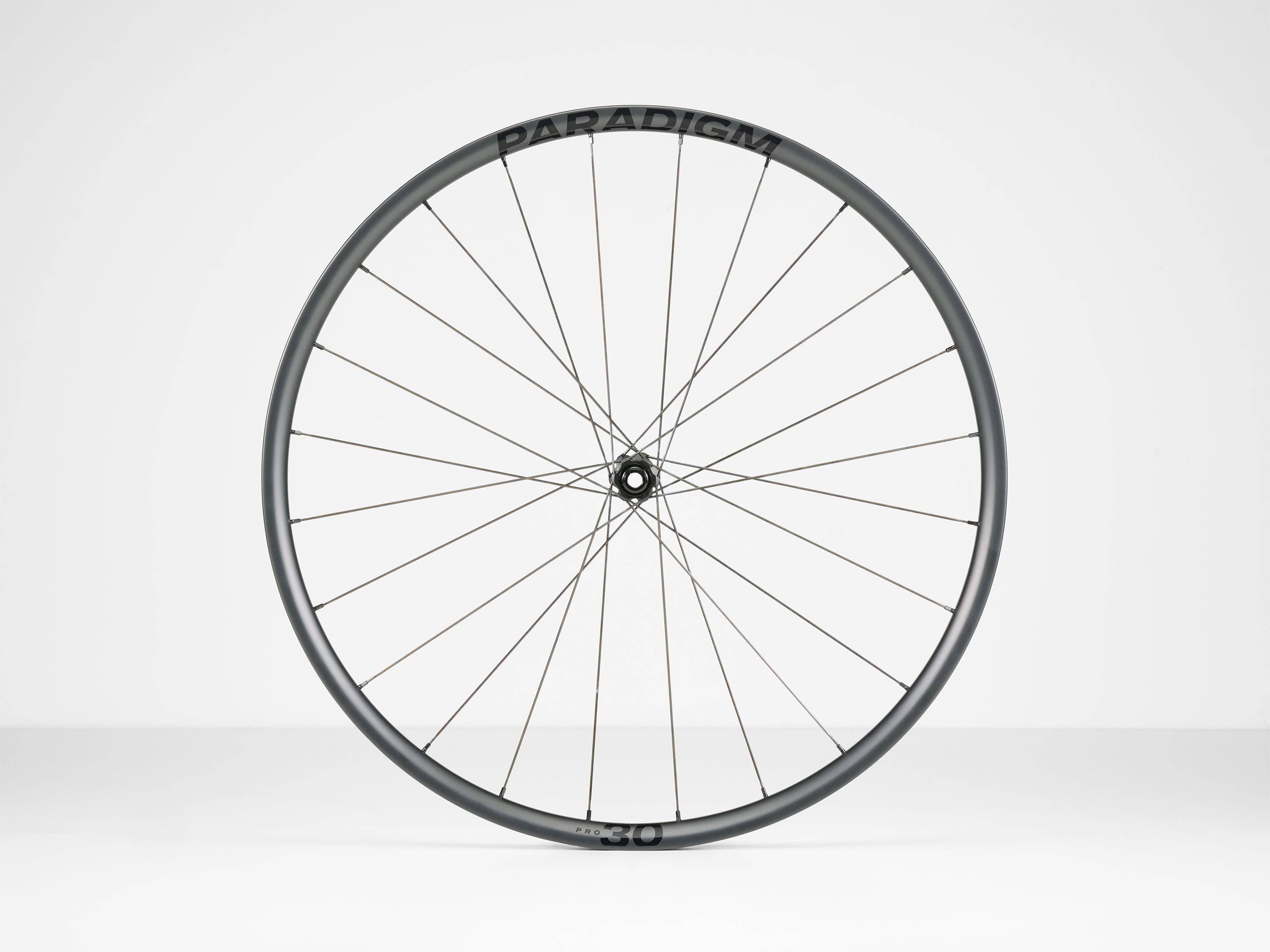 Bontrager Paradigm Pro 30 TLR disc road wheel with aerodynamic tubeless-ready rim and sleek black finish.
