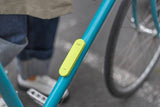 Knog Scout bike alarm and finder with 85dB motion alarm and Apple Find My integration, shown on a bike accessory mount.