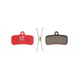 Jagwire Sport semi-metallic disc brake pads for Shimano and RideRever MTB bikes, shown with brake components and mounting hardware.