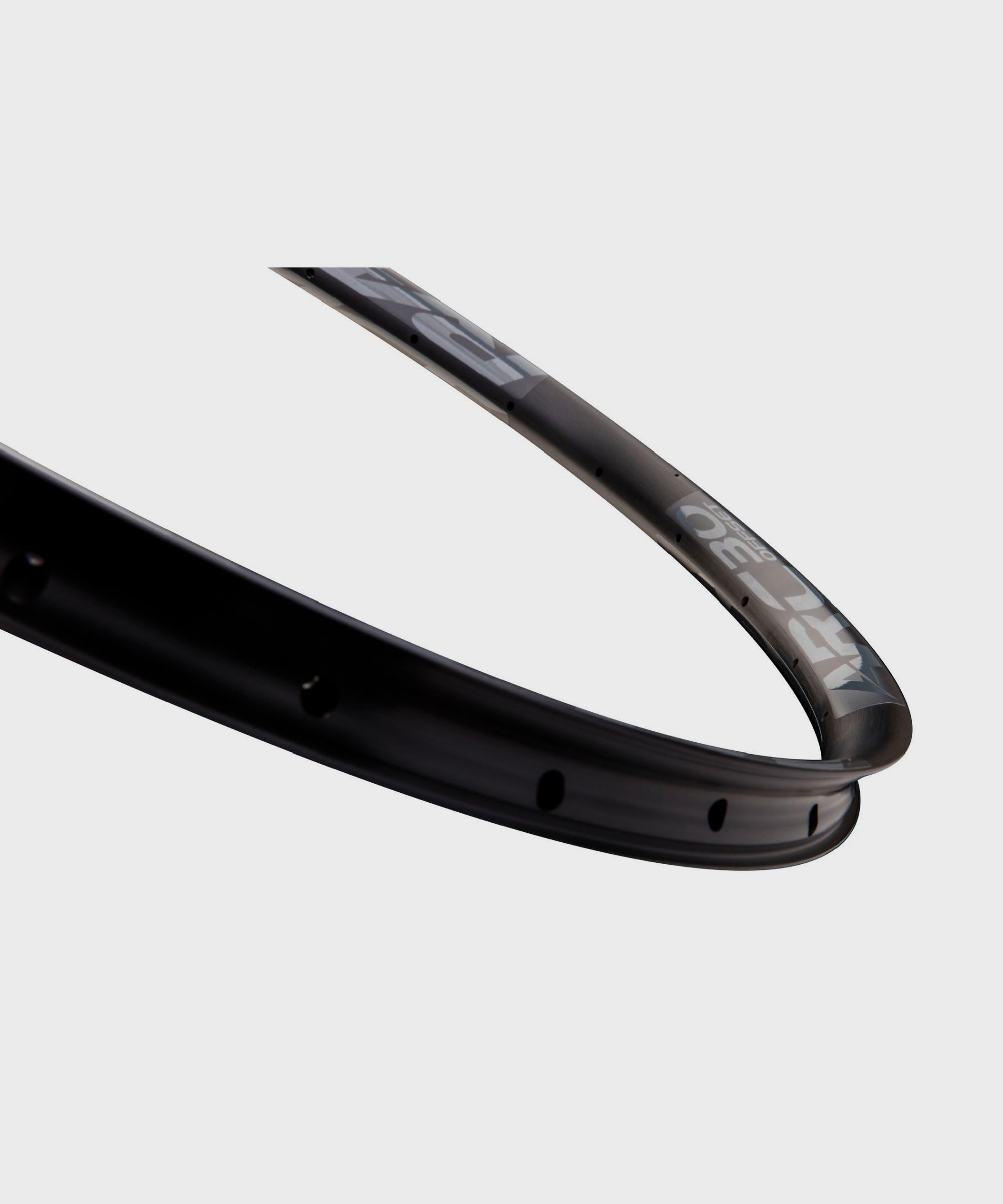 Race Face Arc Offset MTB rim tubeless ready 27.5" and 29" mountain bike wheel rim, black with white branding, close-up shot.