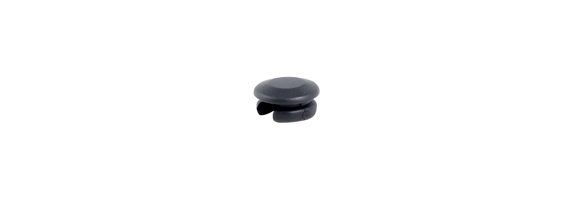 Black round Trek seat tube wire routing frame plug for mechanical shifting cable management on bicycle frame.