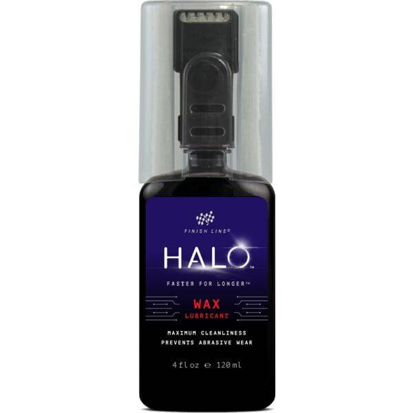 Finish Line Halo Wax bicycle chain lubricant with Smart Luber, shown in workshop setting, designed for drivetrain performance.