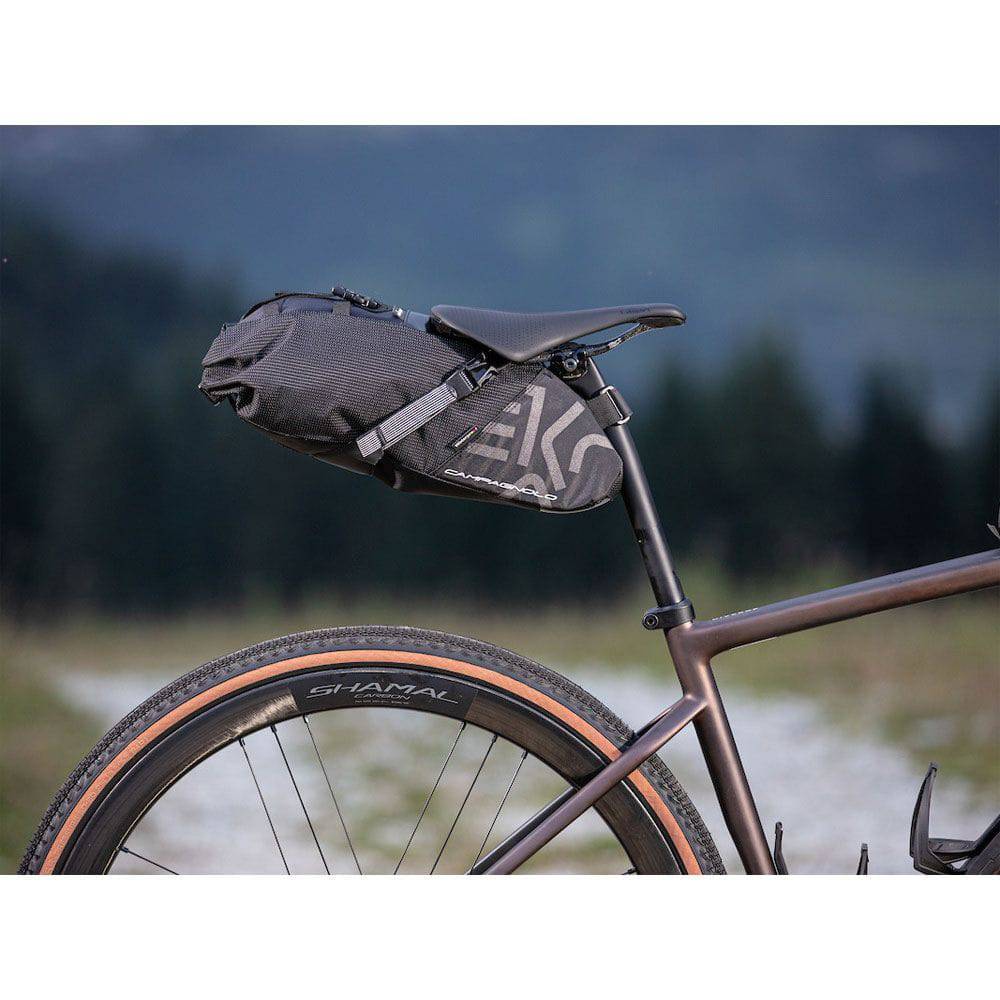 Campagnolo EKAR gravel bike waterproof saddle bag with multiple compartments and secure straps for bikepacking accessories.