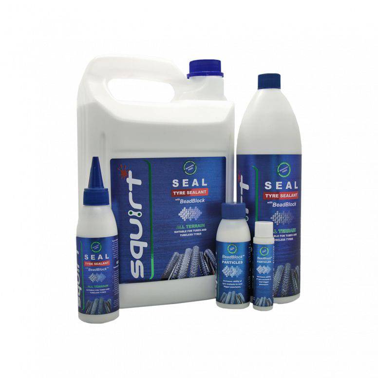 Squirt SEAL Tyre Sealant with BeadBlock for puncture protection on tubed and tubeless wheels in a workshop setting.
