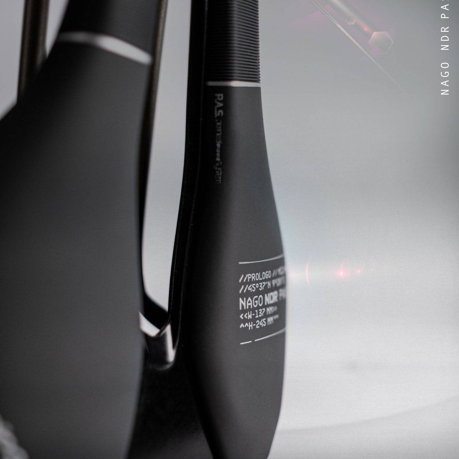Prologo Nago NDR PAS Tirox cycling saddle with ergonomic design for MTB and road bikes, shown on a bike seat.