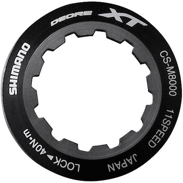 Shimano Spares CS-M8000 lock ring and spacer for cassette maintenance, close-up of components on a bike drivetrain.