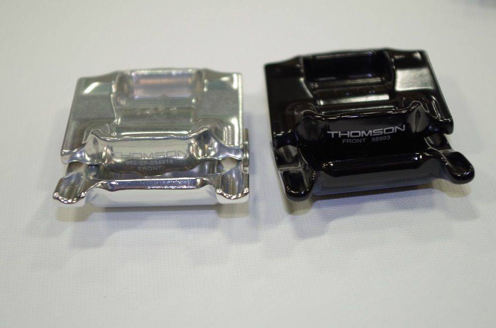 Black Thomson saddle rail clamps for bike seatposts, made of durable metal, designed to secure and adjust saddle position.