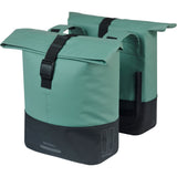 Basil Cove double pannier bag mounted on a bike, water-repellent bike luggage for commuting, in black with reflective accents.