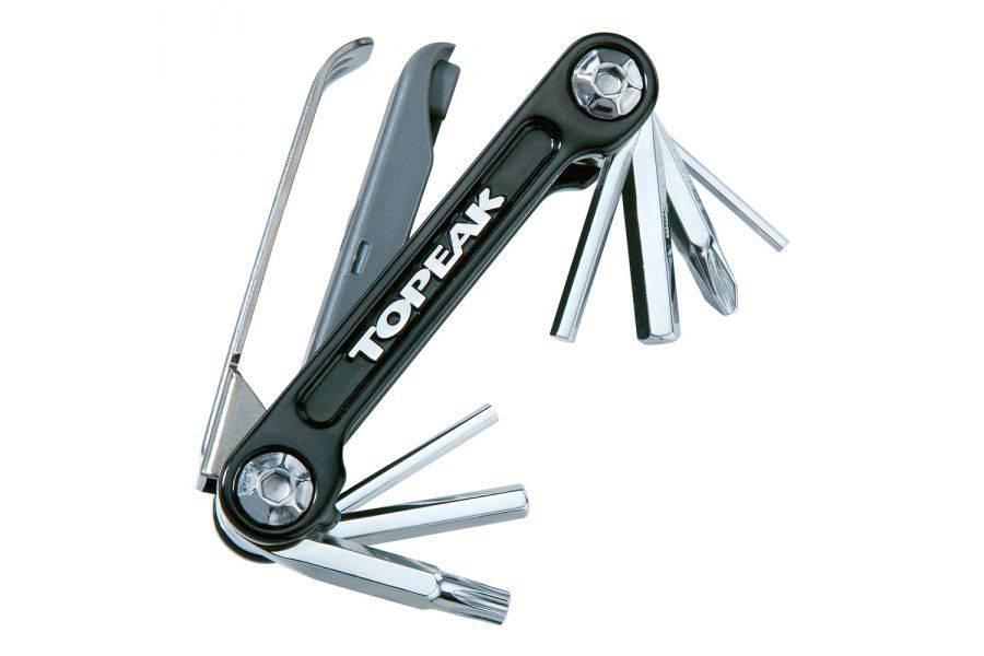 Topeak Mini 9 Pro multi-tool with 9 functions for bike repair, shown in a black neoprene bag on a workshop surface.