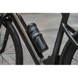 Topeak Escape Pod+ bike storage bag in black, designed for standard bottle cages, showing compact, durable accessories for cycling.