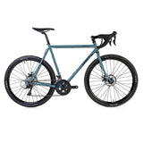 Surly Straggler 650b Sora gravel bike with steel frame, drop handlebars, and knobby tires for versatile commuting and touring.