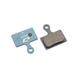 Jagwire Sport Organic disc brake pads for Shimano MTB and RideRever Cargo-x, blue color, close-up of brake pad components.