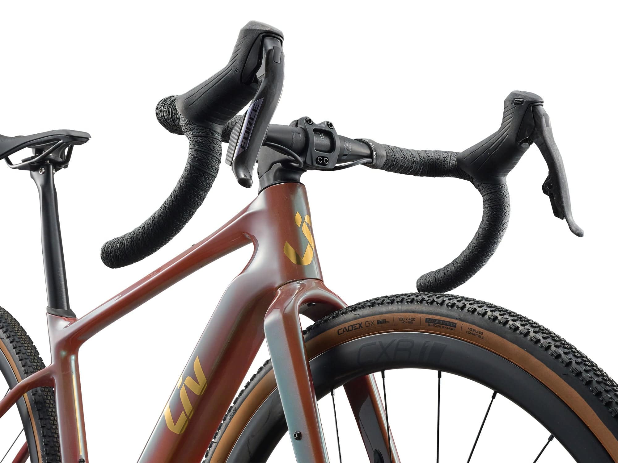 Liv Devote Advanced Pro 2026 women's gravel racing bike with adjustable wheelbase, black frame and knobby tires, ready for rugged trails.