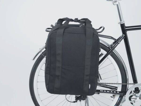 AtranVelo METRO AVS side bag with laptop compartment mounted on a bicycle pannier rack, designed for versatile cycling accessories.