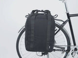 AtranVelo METRO AVS side bag with laptop compartment mounted on a bicycle pannier rack, designed for versatile cycling accessories.