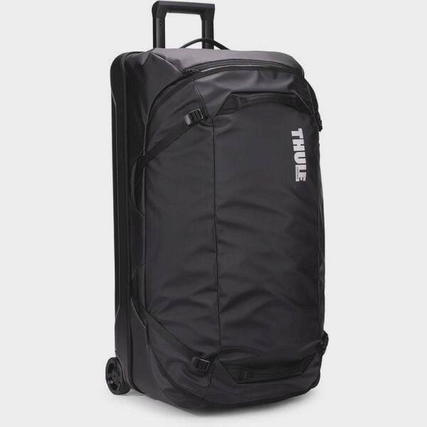 Thule Chasm Rolling Duffel Bag in black, durable weather-resistant travel accessory with sturdy wheels and spacious main compartment.
