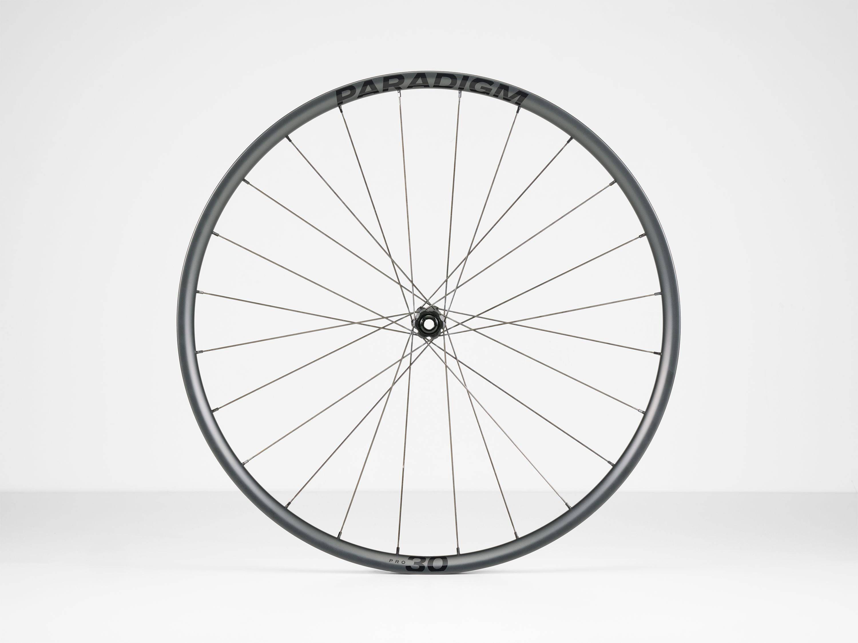 Bontrager Paradigm Pro 30 TLR disc road wheel with aerodynamic design and tubeless-ready setup, suitable for high-performance cycling.