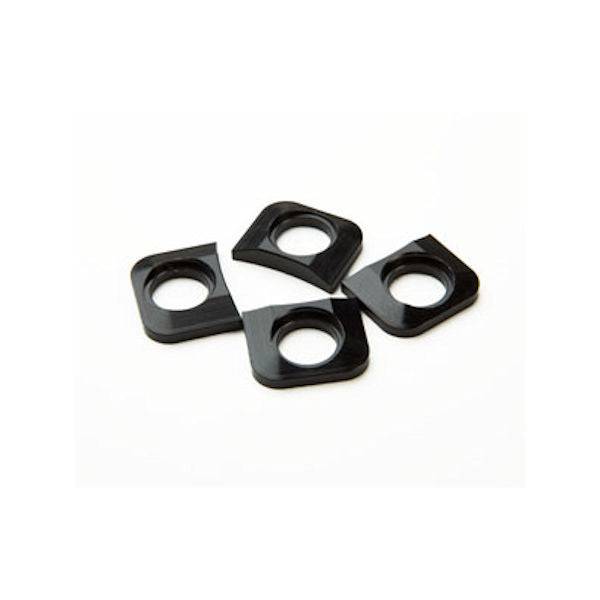 Race Face chainring tab shims pack of 4, spare components for bike cranksets, shown in a close-up image.
