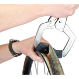 Park Tool BMT-1 bicycle tyre bead breaker for tubeless and tight-fit tires, shown in workshop setting with tools and bike components.