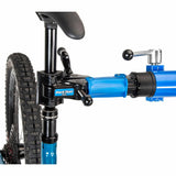 Park Tool PRS-2.4-2 deluxe double arm bike repair stand with 100-3D clamps for stable workshop bike maintenance.