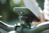 Quad Lock waterproof wireless charging head for bike phone mount, showing secure attachment and charging features.