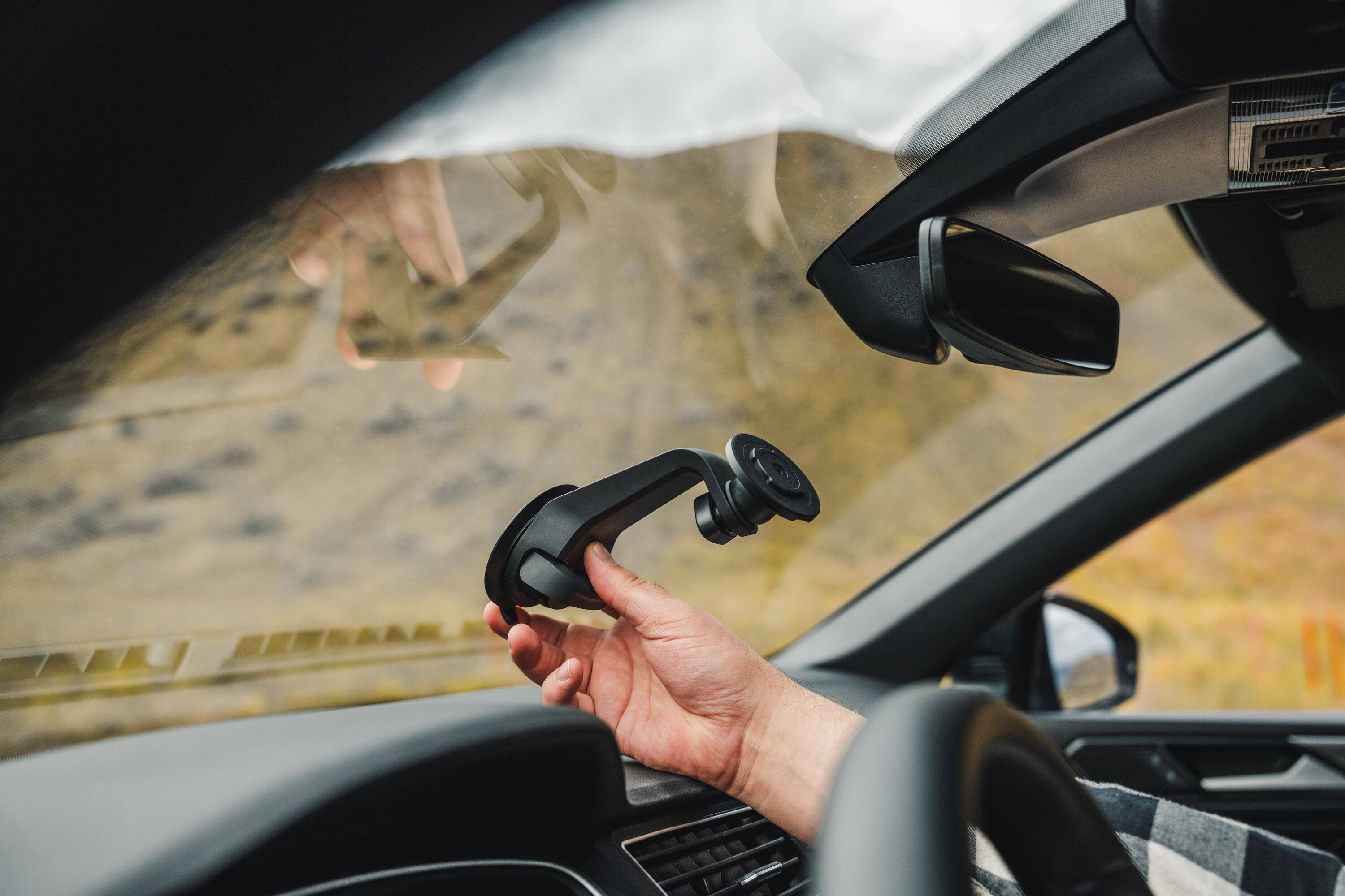 Quad Lock V6 car mount with adjustable 360° gimbal head for window and dash installation, compatible with smartphone accessories.