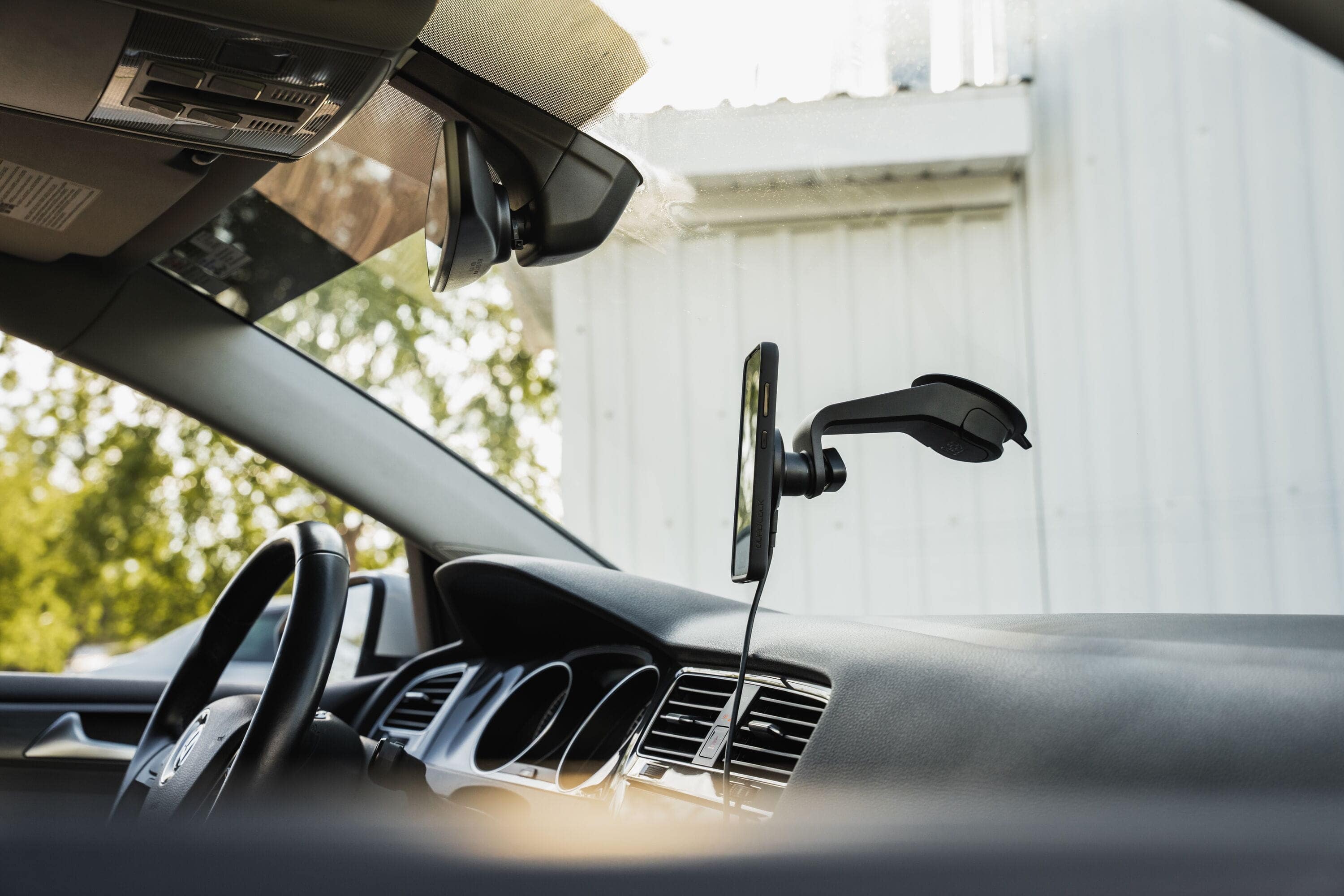 Quad Lock V6 Window and Dash Car Mount with adjustable 360° gimbal head, showcasing the versatile device attached to a vehicle interior.